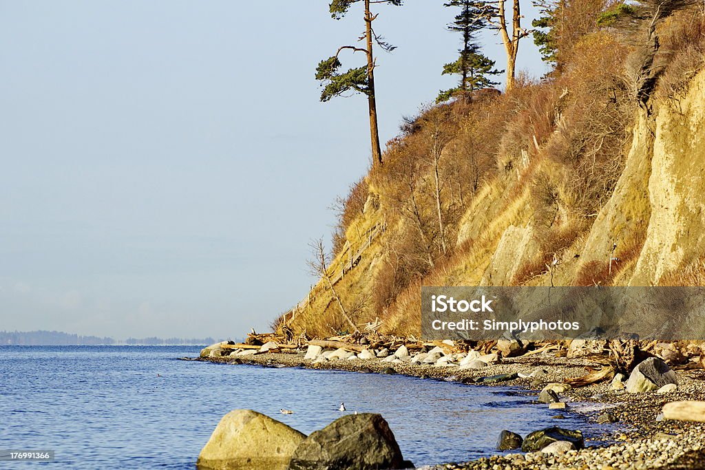 Rocky Hilled Coastline of Birch Bay in Blaine, Washington "A scenic rocky cove lined by sand cliffs and pine trees found in the USA / Canada border town of Blaine, Washington on the Pacific Ocean coast at Birch Bay." Bay of Water Stock Photo