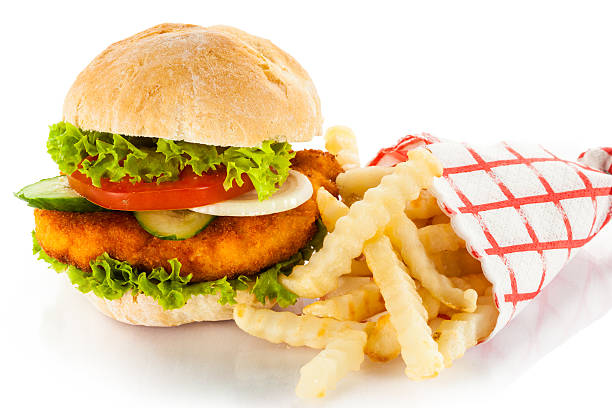 istock Big hamburger with French fries on white background 176991420