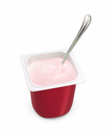 Single-serving pot of strawberry yogurt with spoon isolated on white background. 