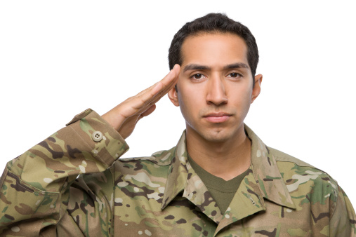 Latino Male soldier in camouflage salutes