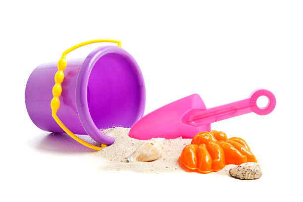 Beach Toys Plastic Beach Toys: Bucket, Shovel and Baking Mould with Sand and Shells sand pail and shovel stock pictures, royalty-free photos & images