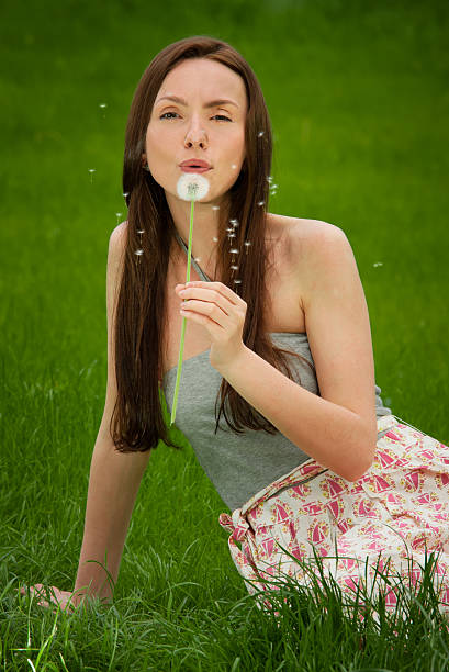Girl with dandelion on green fieldGirl with dandelion on green field