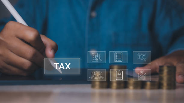 istock Businessman using tablet Individual income tax payment with stack coins. 1769933685