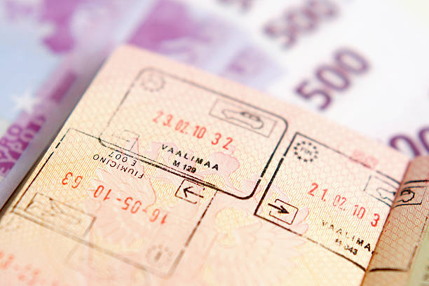 istock Passport with stamps on a money background 176993562