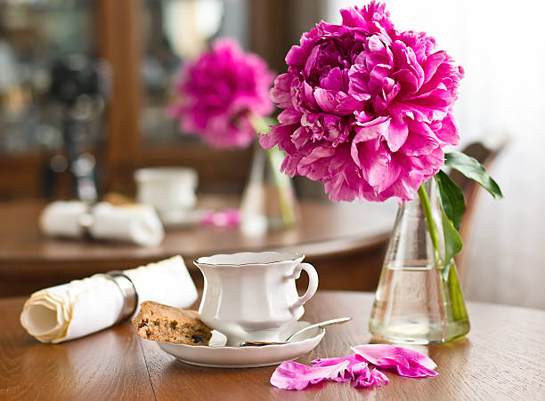 istock A cup of tea and biscuits with a pink flower bouquet 176993585
