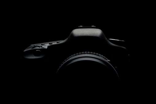 Digital camera silhouette over black background