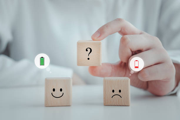 istock Hand holding question mark between smiling with full battery and sadness with low battery. Energy life, emotion level, passion, burnout syndromes, world mental health day, mental health assessment. 1769941542