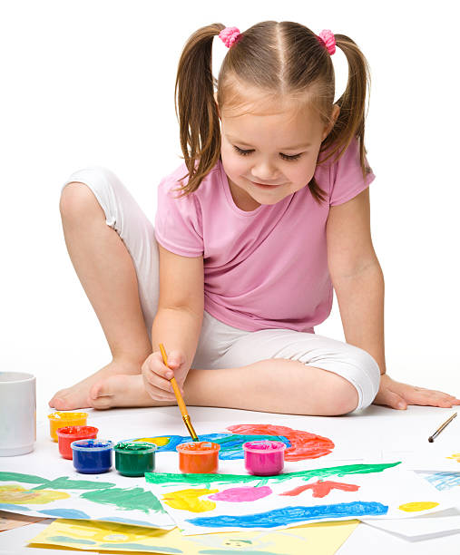 Cute cheerful child play with paints stock photo