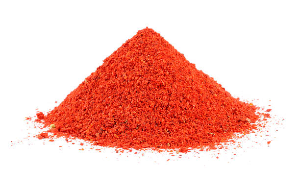 Pile of Paprika Powder A pile of paprika powder isolated on a white background red pepper powder stock pictures, royalty-free photos & images