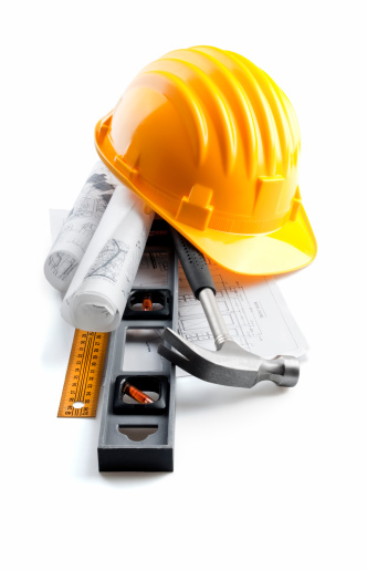 isolated hard hat with tools and blueprint on white