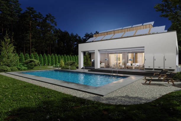 istock Modern Villa Exterior With Home Battery Storage System On Building Facade And Solar Panels On The Roof At Night 1769953370