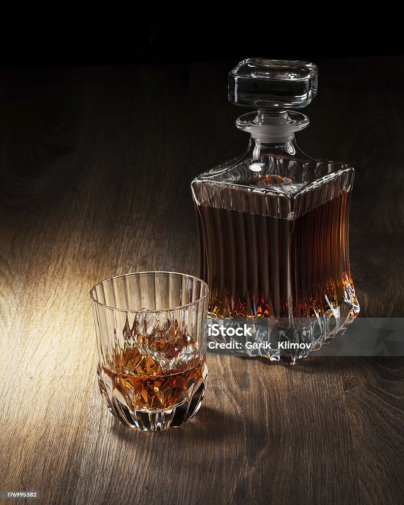 glass and bottle with whiskey on a woden table  Decanter Stock Photo