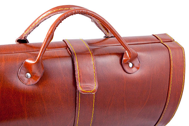 istock brown leather bag on white, closeup 176995591