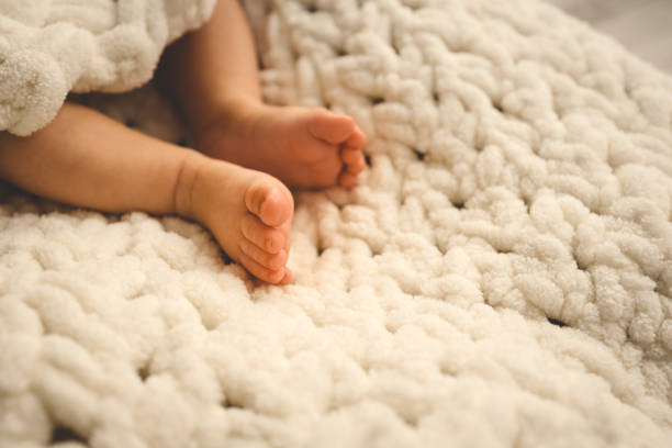 istock New Born Baby Feet on White Blanket 1769956810