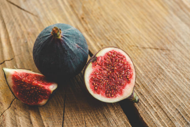 istock A few figs in a bowl on an old wooden background. 1769962810