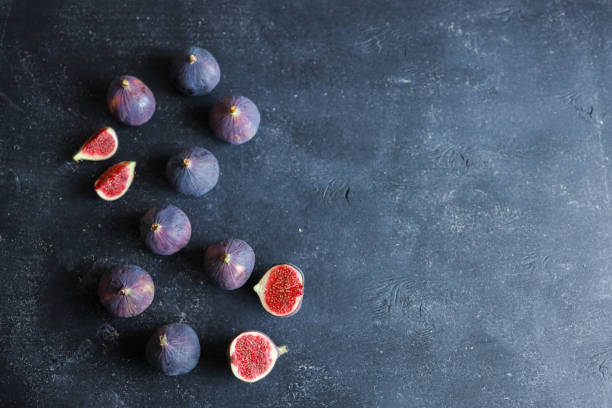istock fresh ripe figs on dark background, top view 1769962865