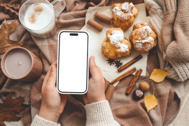 istock Phone with an isolated screen in hands, autumn mood 1769963380