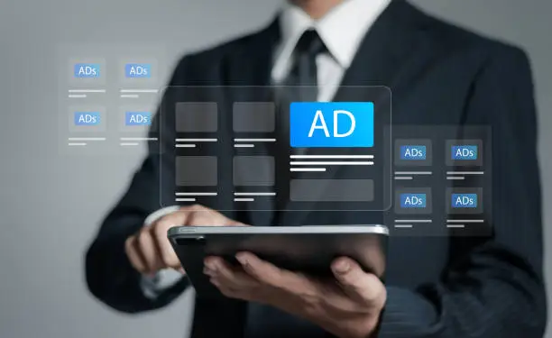 Photo of Programmatic advertising concept. Businessman use tablet with advertising on website, planning advertising marketing strategies to target social media native, ad, advertisers, sales, marketing digital