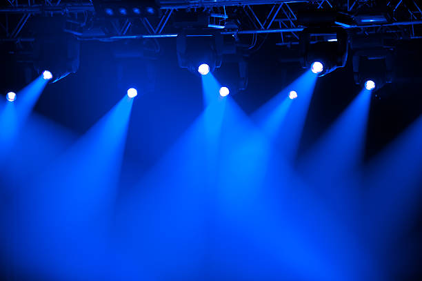 Futuristic blue spotlights on stage Blue stage spotlights stage light stock pictures, royalty-free photos & images