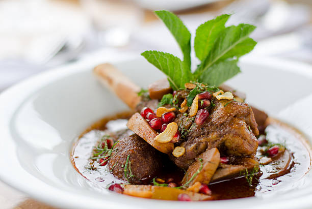 Plated leg of lamb on a white plate