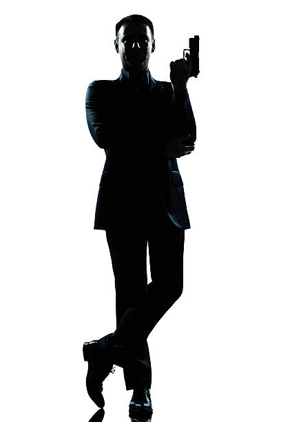 istock Isolated silhouette of a man holding a gun 176997318