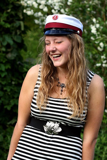 Happy danish student graduated from High School Young Danish woman who just graduated from the 'Gymnasium' (Danish for High School or upper secondary school).Ung dansk kvinde med roed studenterhue. Hun er lige blevet student fra det almene gymnasium (STX). danish culture stock pictures, royalty-free photos & images