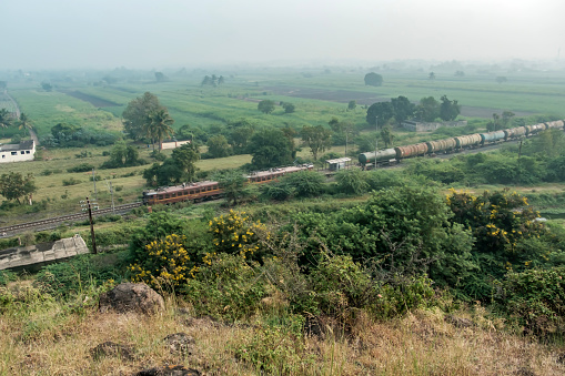 Pune, India - October 22 2023: Oil tanker train hauled by a WAG7 electric locomotives near Pune India.