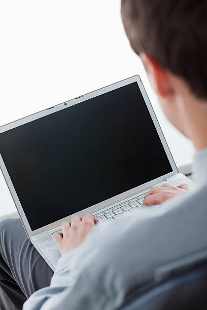 istock Back view of a businessman typing on his laptop 177000185