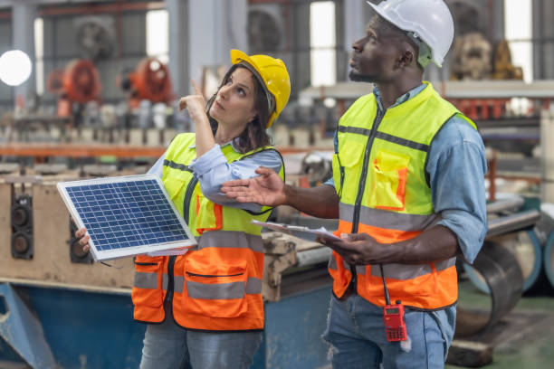 istock Factory metal workers install solar panels, cut costs, earn carbon credits, combat climate change. 1770004484