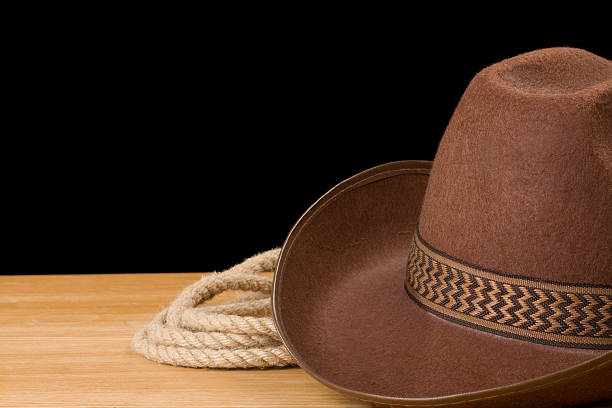 istock brown cowboy hat and rope isolated on black 177000461