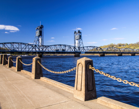 Stillwater Lift Bridge on a warm day with walking path featuring pedestals with chain in the foreground.
