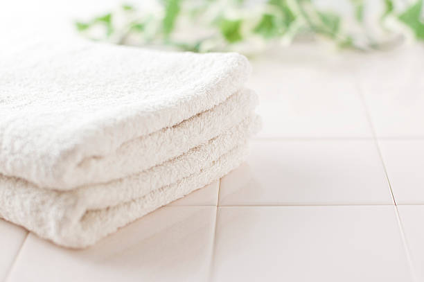 istock White towels and green on tile 177000810