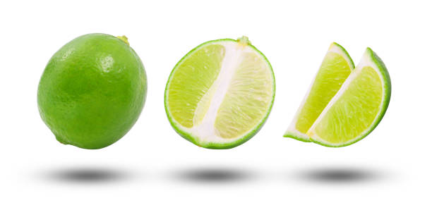 istock Flying lime and half slices isolated on white background. 1770009291