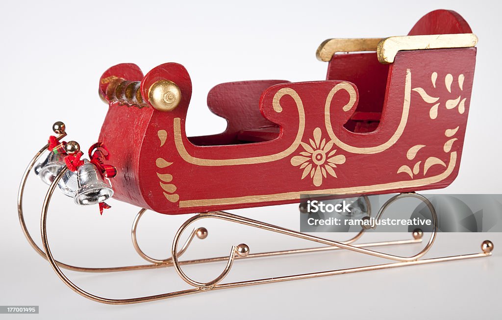 Classic Santa Sleigh "Classic Wooden toy Santa Sleigh, with gold trimmings, and silvers bells. Shot on white background side view." Animal Sleigh Stock Photo