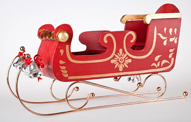 Classic Santa Sleigh "Classic Wooden toy Santa Sleigh, with gold trimmings, and silvers bells. Shot on white background side view." animal sleigh photos stock pictures, royalty-free photos & images