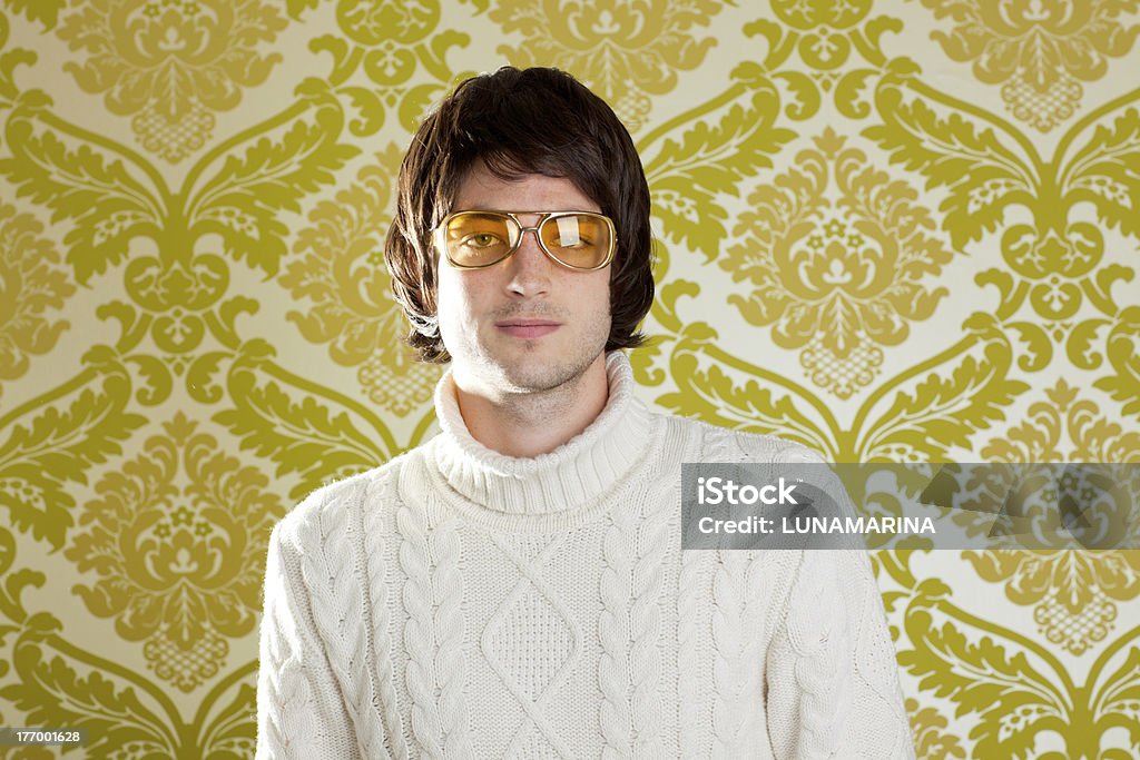 retro man vintage glasses and turtleneck sweater retro hip young man with vintage glasses and winter  turtleneck sweater on wallpaper 1970-1979 Stock Photo