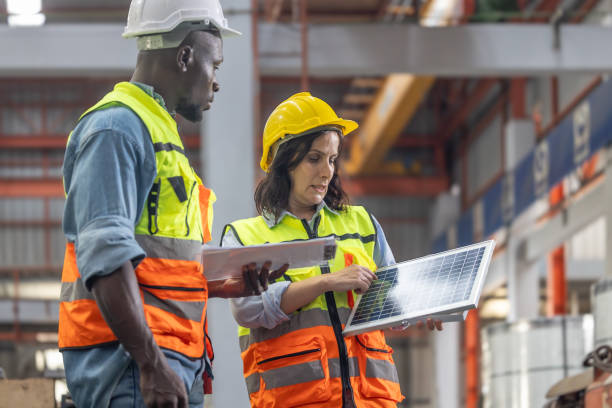 istock Factory metal workers install solar panels, cut costs, earn carbon credits, combat climate change. 1770017344