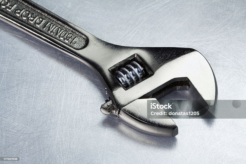 Metal tool "Spanner, wrench on a metal table" Adjustable Wrench Stock Photo