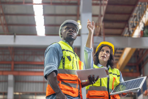istock Factory metal workers install solar panels, cut costs, earn carbon credits, combat climate change. 1770019479