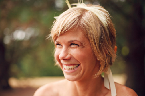 Pretty young woman with short hair smiling.