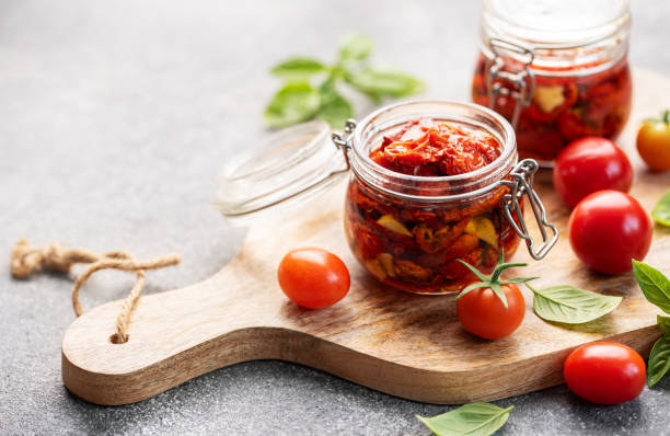 istock Jars with sun dried tomatoes with fresh herbs and spices. 1770023232