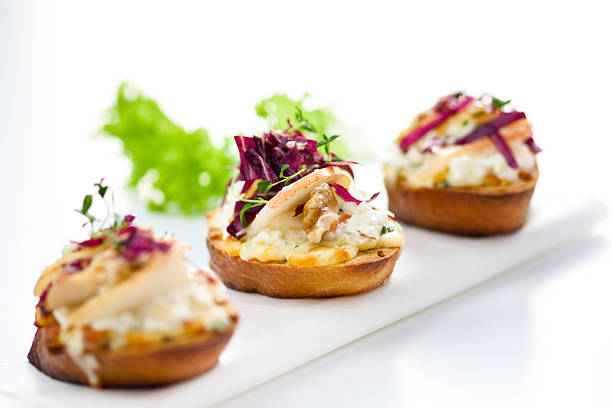 italian appetizer crostini with pear, radicchio and cheese stock photo