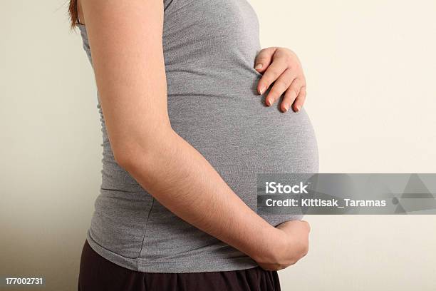 Pregnant Asian Woman Caressing Her Belly Warm Tone Color Stock Photo - Download Image Now