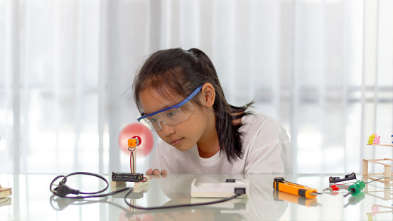 Young girl Learning robotics basics