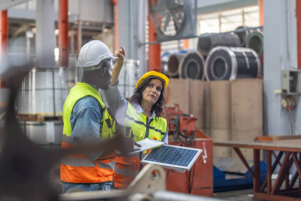 istock Factory metal workers install solar panels, cut costs, earn carbon credits, combat climate change. 1770034611