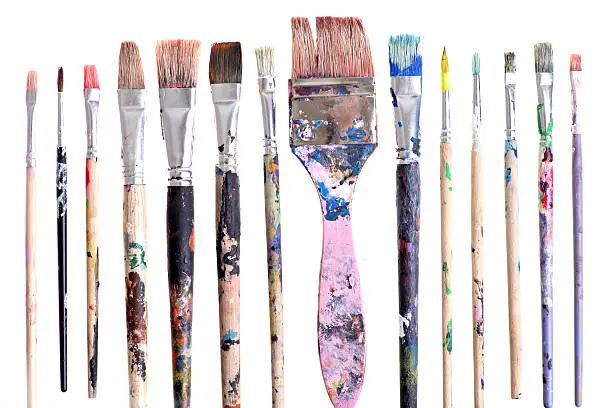 Various dirty paint brushes displayed side by side