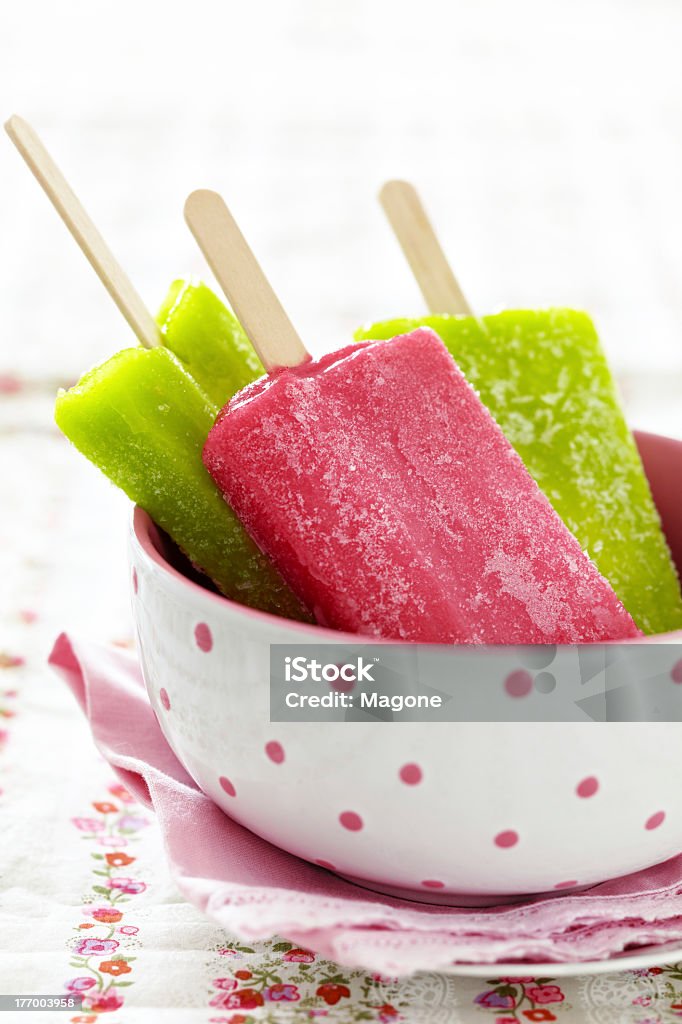 Colorful ice lollies served in a white & pink bowl homemade ice cream Bowl Stock Photo