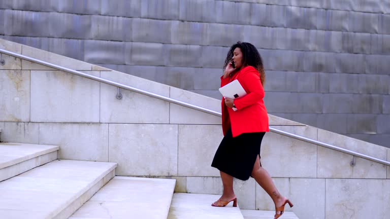 Curvy businesswoman walking on stairs