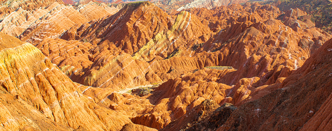 Panorama of the terracotta rocks of Rainbow mountains in Zhangye Danxia National Geopark, Gansu Province, China. Blue sky with copy space