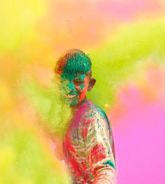 Close-up of a young boy playing Holi in India.